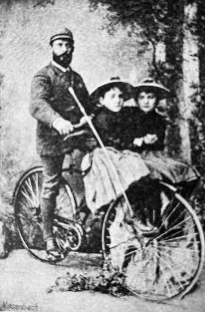 istock Father showing his bicycle with two seats in front for children on the handlebar 1263105393