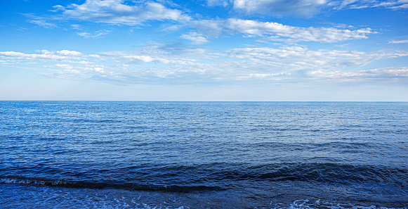 Seascape at sunset. Beautiful evening sky at sunset and sea surf.