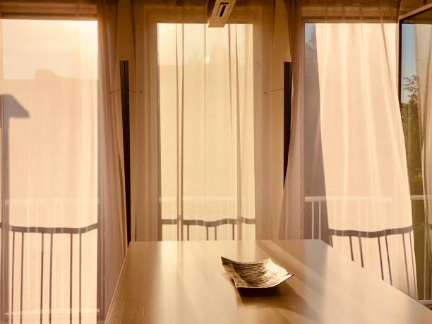 istock Golden morning sun in the blowing curtains 1263106240