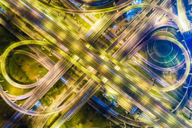 istock Intersection transport road with vehicle light movement 1263107318