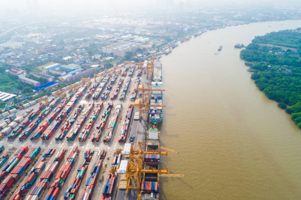 istock Cargo logistic container shipping with boat in city building 1263107369