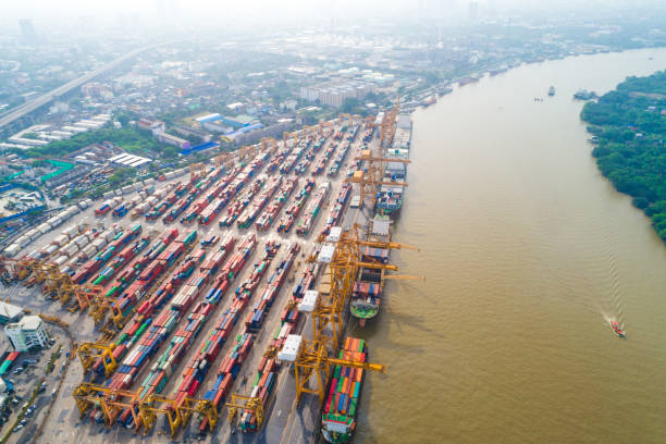 istock Cargo logistic container shipping with boat in city building 1263108118