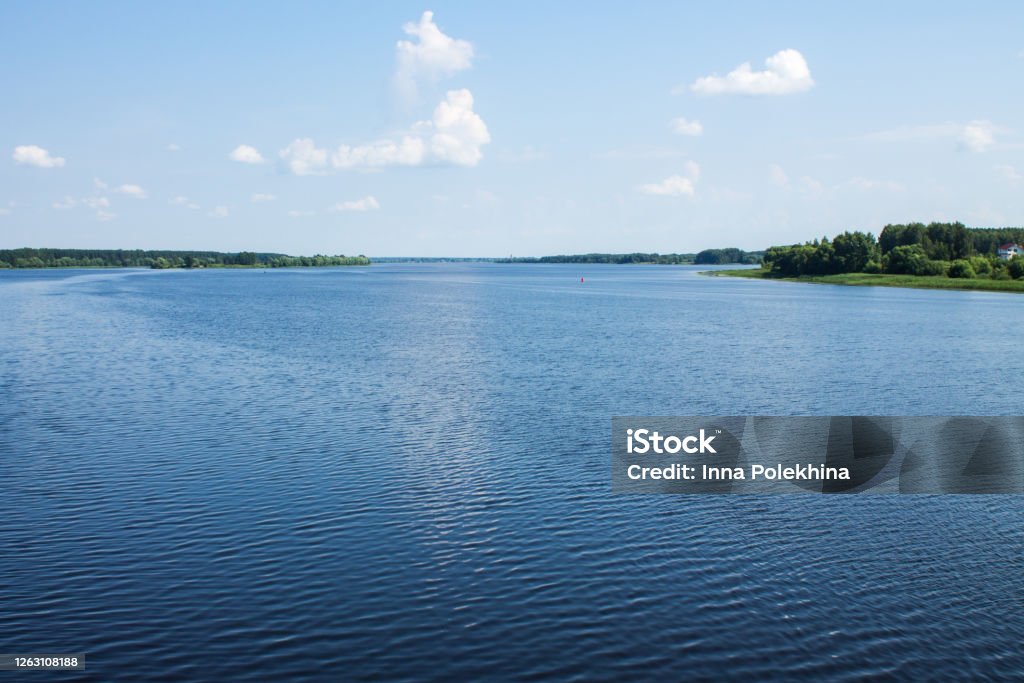 The wide riverbed of the Volga river The wide riverbed of the Volga river and the blue cloudy sky on a clear summer day and space for copying Lake Stock Photo