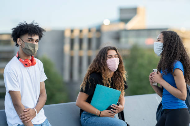 istock Multi-ethnic group of students wearing masks on campus 1263108266