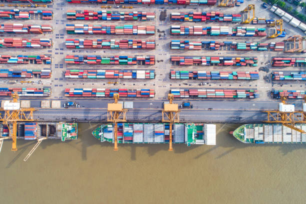 istock Cargo logistic container shipping with boat in city building 1263108998