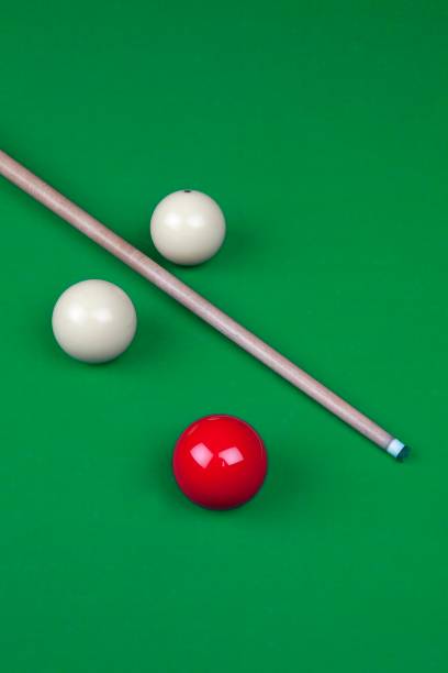 Billiard balls, cue and chalk on a blue pool table. Viewed from above. Horizontal image.