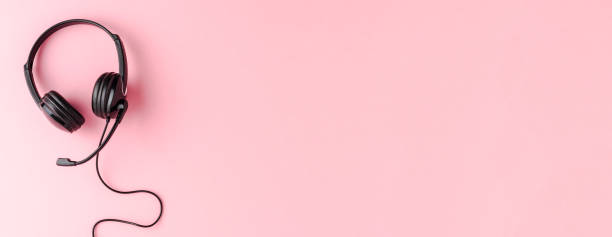 istock Call center concept with helpdesk headphones on pink background with copyspace. Banner 1263109316