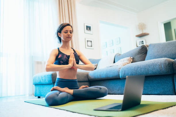 istock Woman practicing yoga at home 1263114730