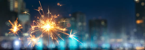 istock Happy New Year, Sparkler with blurred city light background 1263117145