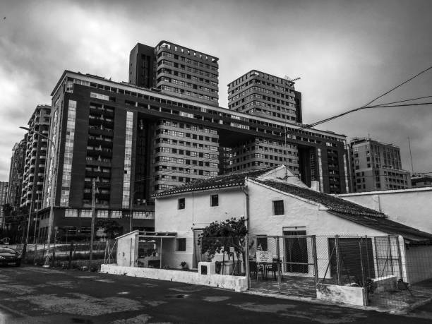 Valencia, Spain - July 3, 2020: Traditional house still standing next to modern buildings. The city is in constant development but there are also lots of old houses standing