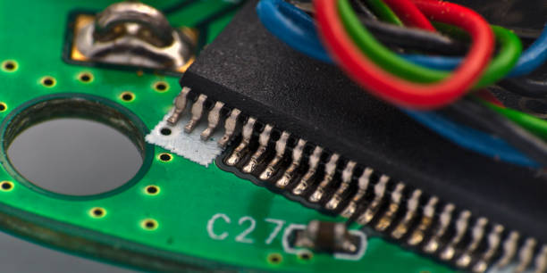 istock Green Circuit board, components and wires, macro photograph 1263123249