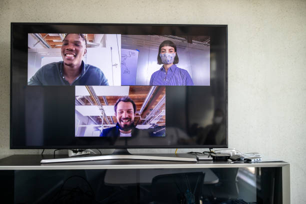 Business people seen on computer monitor during a video call. Business professionals having high tech meeting during pandemic.