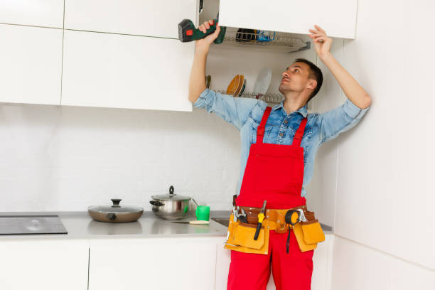 istock Handyman fixing kitchen's cabinet with screwdriver 1263132361