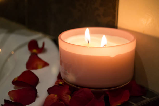 istock Candles and rose petals close up. 1263133100