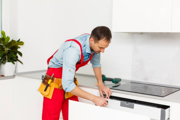 istock Handyman fixing kitchen's cabinet with screwdriver 1263134181