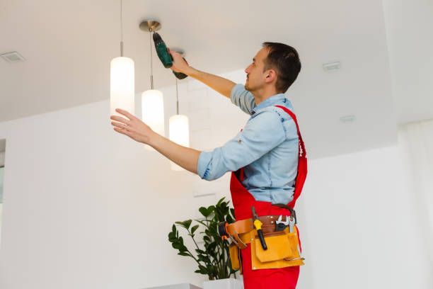 istock Electrician is installing and connecting a lamp to a ceiling. 1263134478