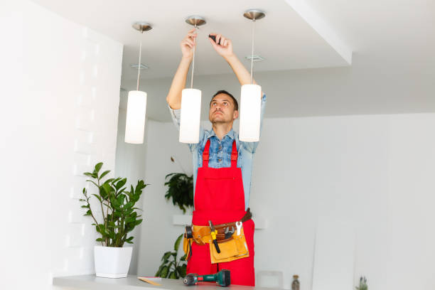 istock Electrician is installing and connecting a lamp to a ceiling. 1263134512