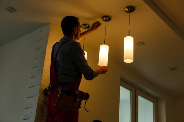 istock Electrician is installing and connecting a lamp to a ceiling. 1263134553