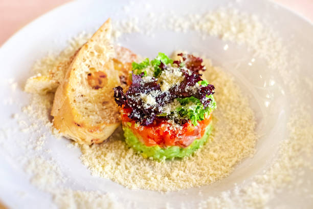 Tartare with salmon, herbs and parmesan. Selective soft focus