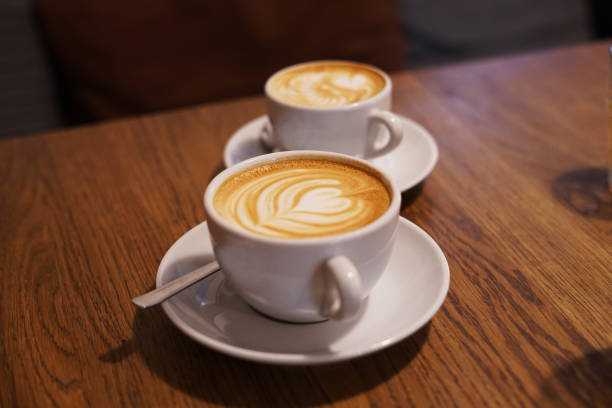 istock Two cups of coffee Latte art created by pouring microfoam 1263137667