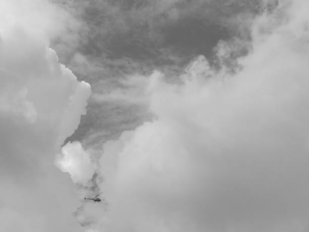 istock Helicopter in the cloudy sky 1263138144