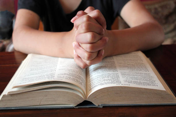 istock praying hands with bible  background and copy space 1263140712