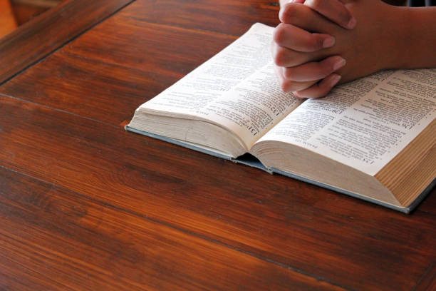 istock praying hands with bible  background and copy space 1263140726