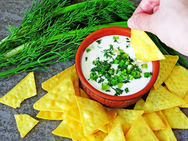 istock Chips with white sauce and greens. 1263140957