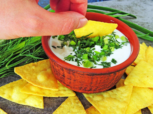 istock Chips with white sauce and greens. 1263140971