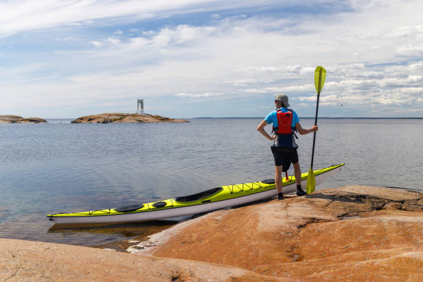 istock A man with a sea kayak on the seashore. 1263141909