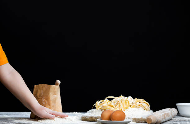 a boy dabbles with wheat flour