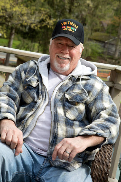 istock Vietnam Veteran sitting in back yard looking at camera grinning 1263145659