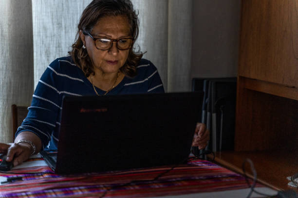 istock Attractive senior Hispanic at laptop 1263152240