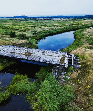 A small bridge crosses a dykelands river.