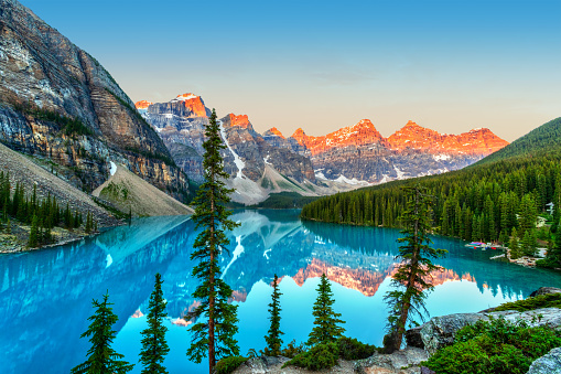 Golden sunrise over the Valley of the Ten Peaks with glacier-fed turquoise-colored Moraine Lake in the foreground near Lake Louise in the Canadian Rockies of Banff National Park.