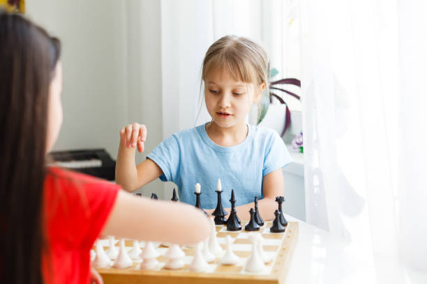 istock Two little sister playing chess at home 1263155809