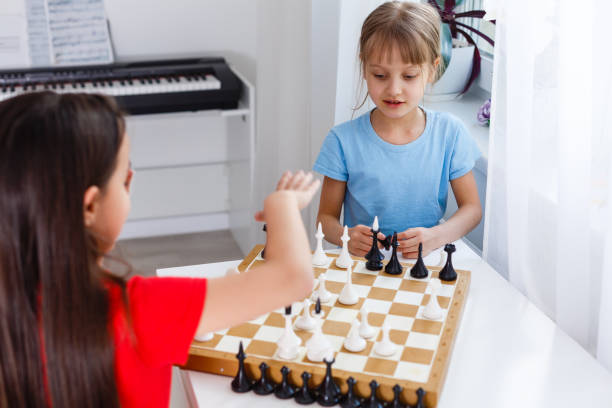 istock Two little sister playing chess at home 1263155936