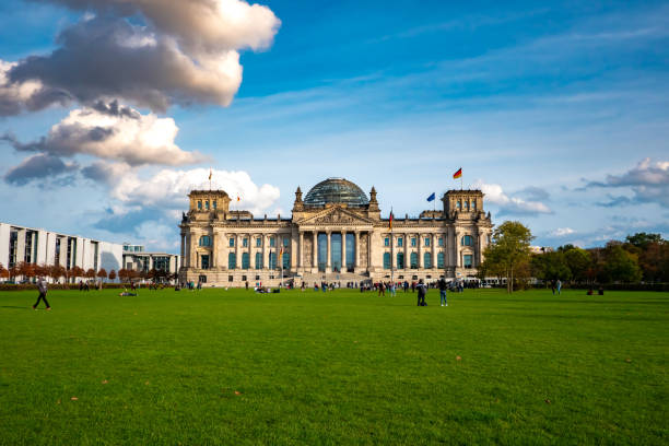 View on the Reichstag building in Germany View on the historic Reichstag Building, seat of the German parliament, as people pass by circa November 2019 in Berlin, Germany. chancellor photos stock pictures, royalty-free photos & images