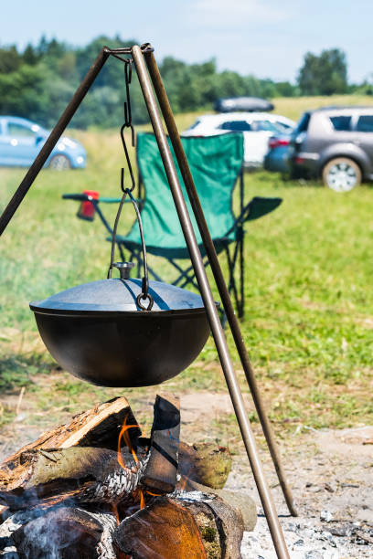 istock Camping bowler hat hangs over the fire on a tripod 1263159843