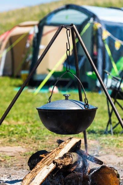 istock Camping bowler hat hangs over the fire on a tripod 1263159882