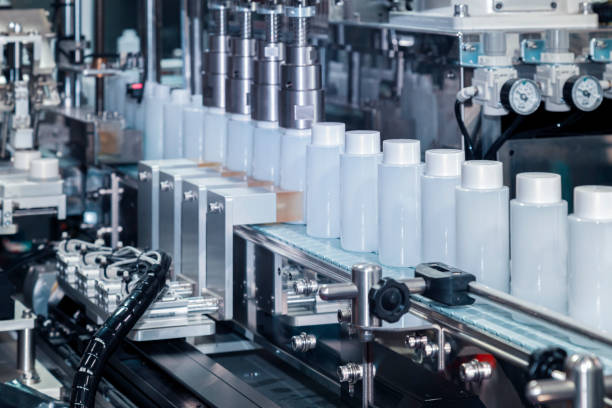 istock white plastic bottle moving on conveyor belt of auto capping and labeling machine at cosmetic and skin care manufacturing. cosmetic industry and ai technology machinery concept. 1263163989