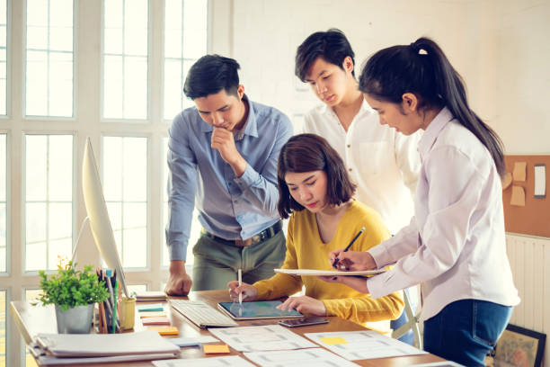 istock Group of young asian creative people. Mobile application designers and website designers brainstorm and planning project work together. 1263164059