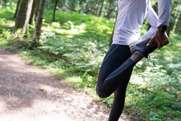 istock Young female Runner Warming Up Before Running In Forest 1263165109