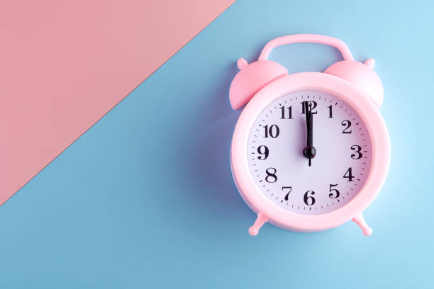 istock alarm clock on pastel color background in copy space. 1263165597