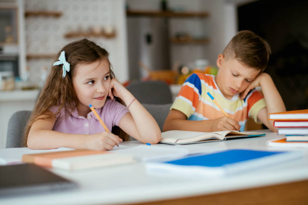 istock Elementary school kids doing homework at home stock photo 1263165626