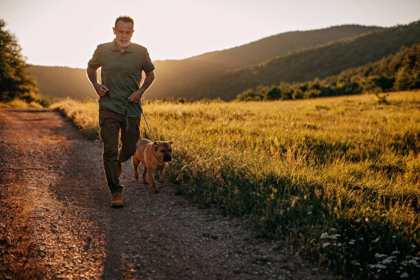 istock Senior man walking his dog 1263166602