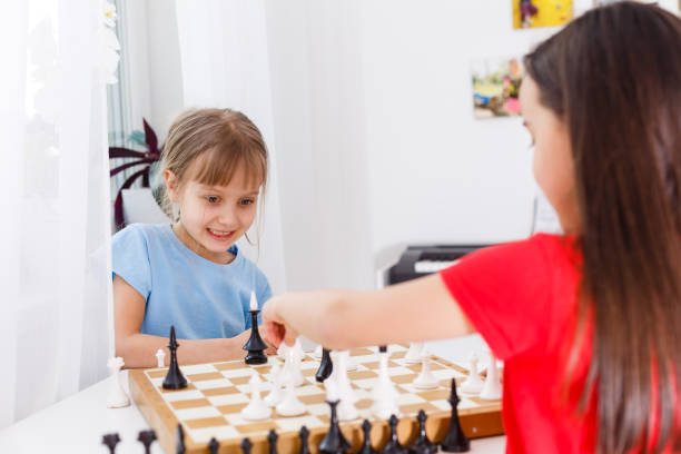 istock Two cute children playing chess at home 1263168760