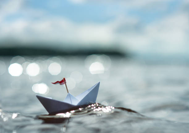 istock Paper Boat on Sunny Sea 1263168862