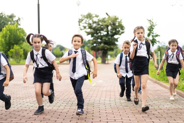 istock Young school kids running to school 1263170029