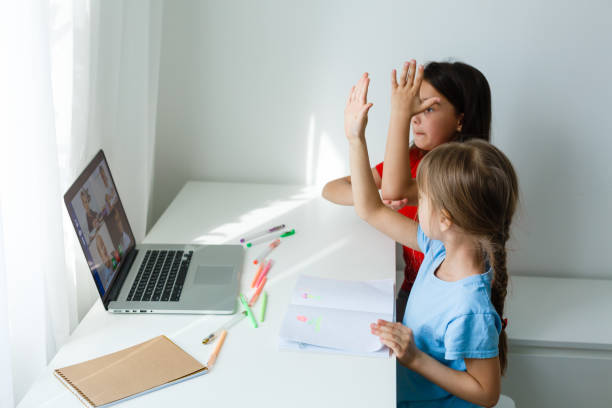 Learning from home, Home school kid concept. Little children study online learning from home with laptop. Quarantine and Social distancing concept.